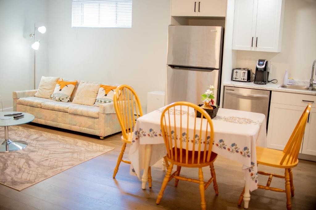 a kitchen and living room with a table and chairs at Cozy One bedroom Apartment in Moncton