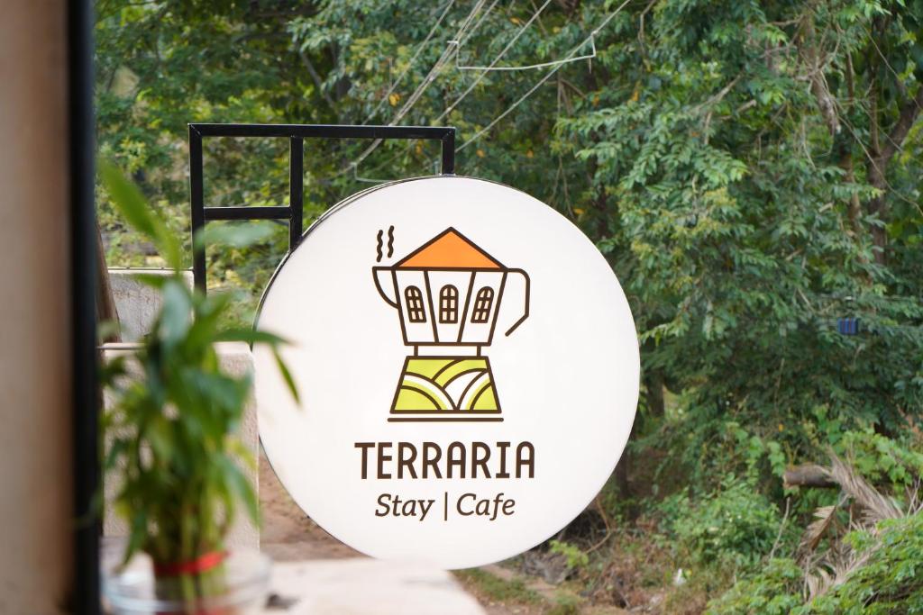 a sign for the terra stay café at Terraria Stay and Cafe in Canacona