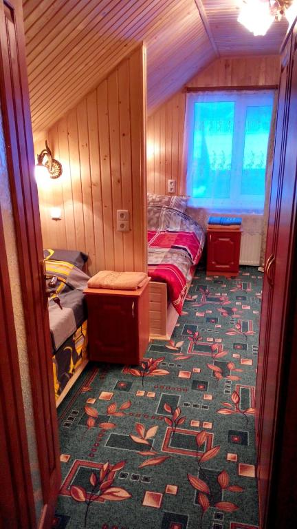 Postel nebo postele na pokoji v ubytování Cottage Ozerniy