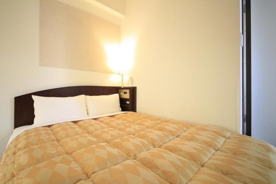 Postel nebo postele na pokoji v ubytování Fuchu Urban Hotel Annex