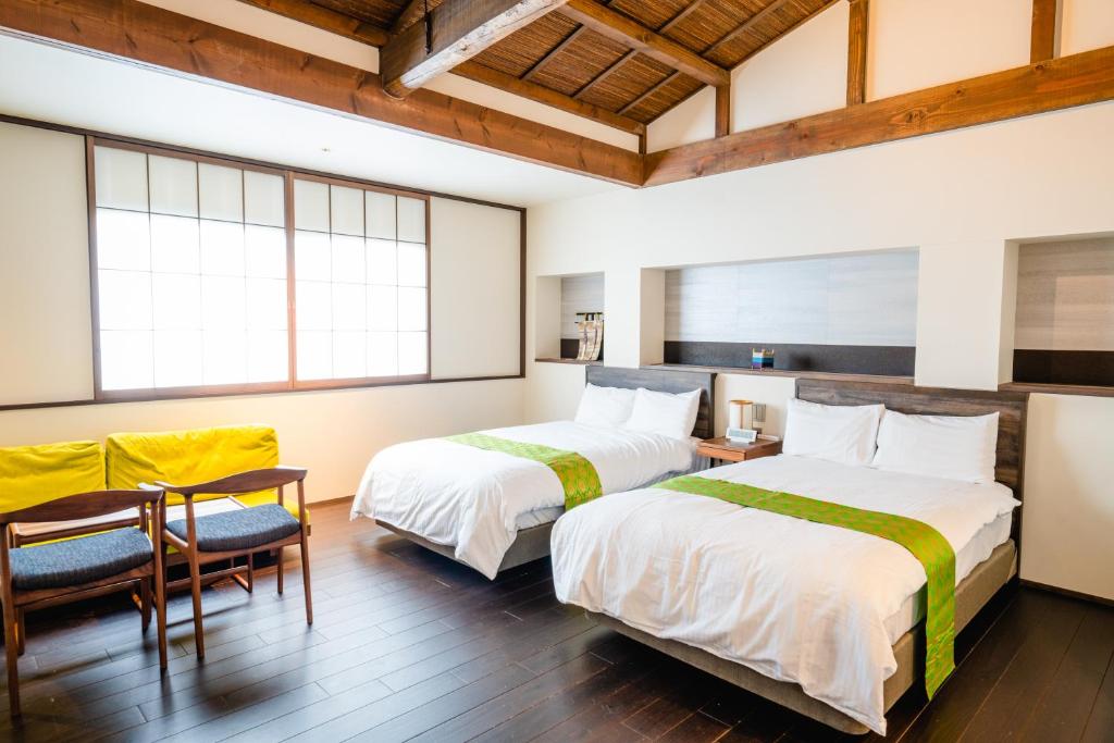 Postel nebo postele na pokoji v ubytování Hotel Rakurakuan
