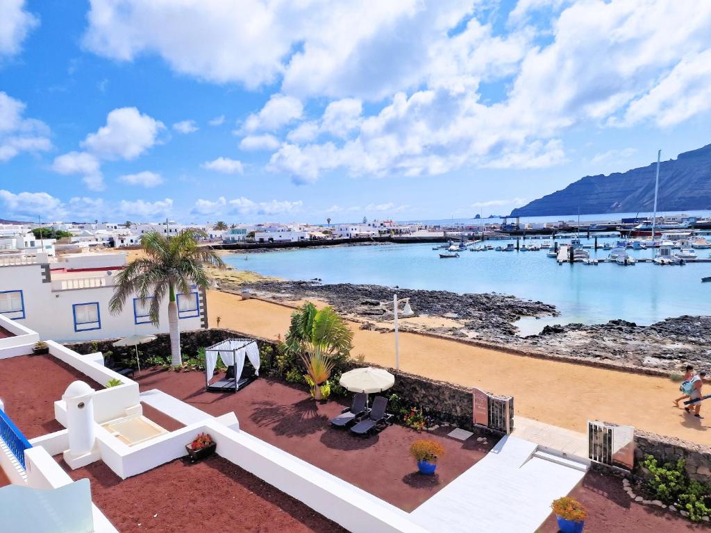 a view of the beach from the balcony of a house at Evita Beach Suites Exclusivas in Caleta de Sebo