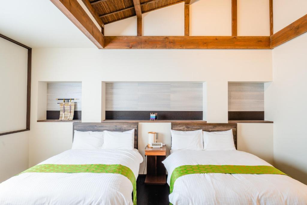 Postel nebo postele na pokoji v ubytování Hotel Rakurakuan