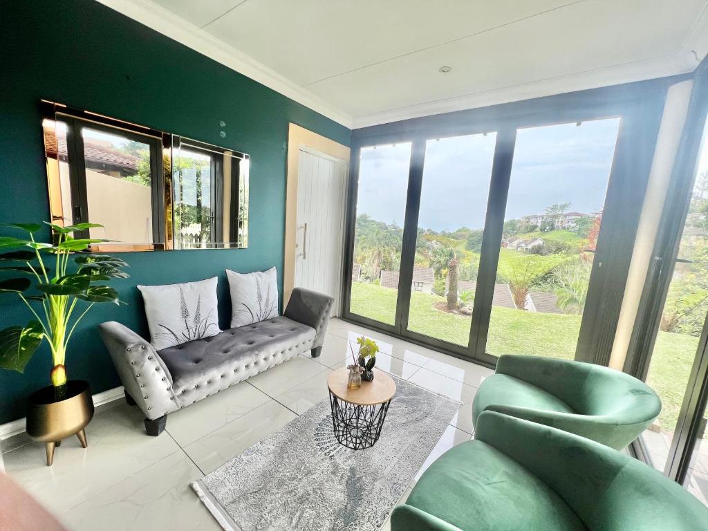 a living room with a couch and a table at Forest View Villa in New Germany