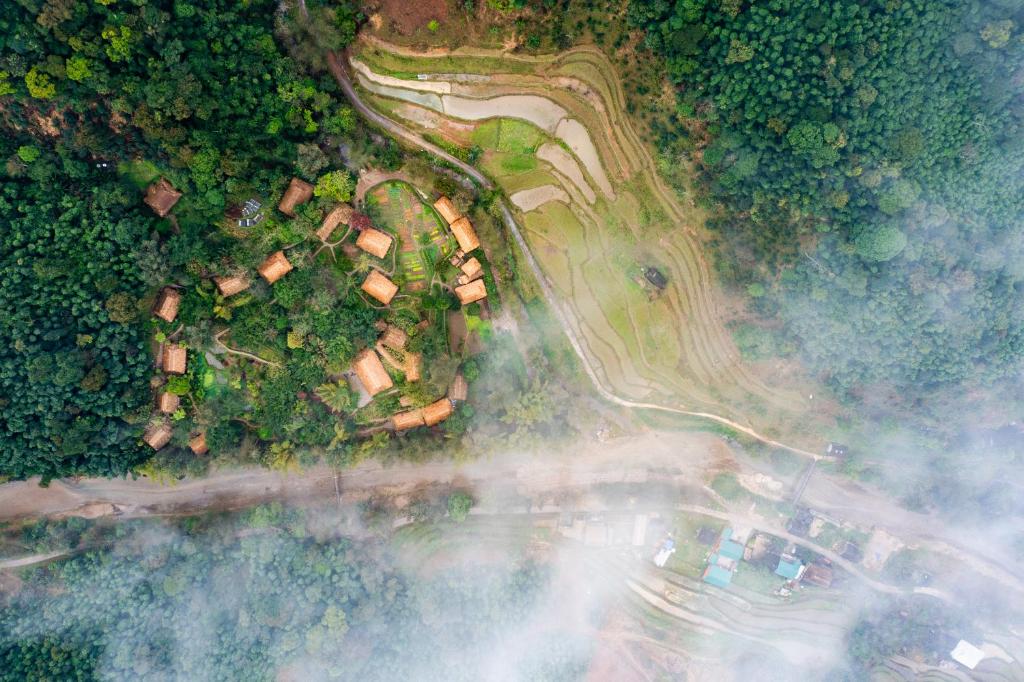 an aerial view of a house with trees and a road at Panhou Retreat in Ha Giang
