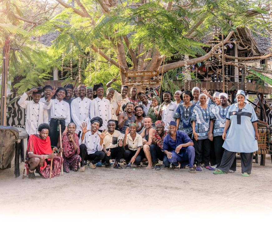 a group of people are posing for a picture at Makofi Guest House in Nungwi