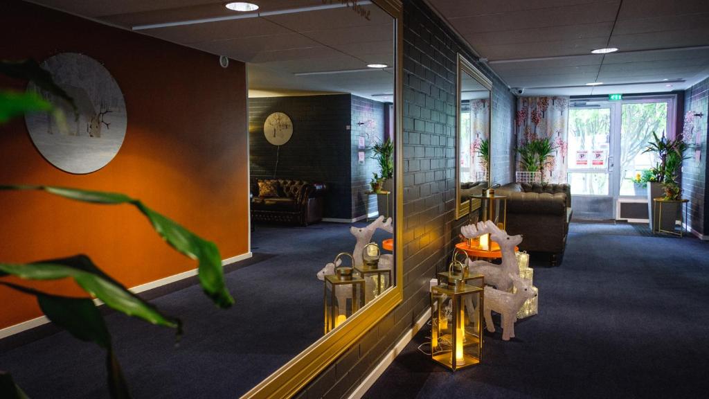 a living room with a couch and a mirror at Hotel Golden Circle Suites in Rovaniemi