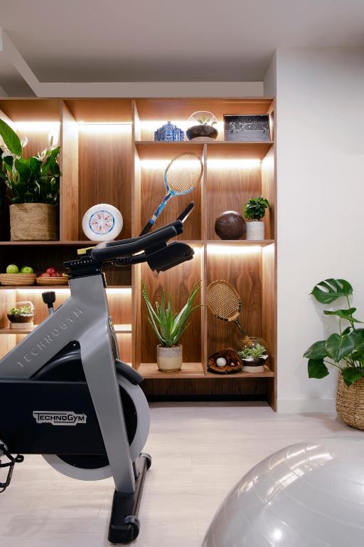 a treadmill in a room with plants and shelves at Meliá Lloret de Mar in Lloret de Mar
