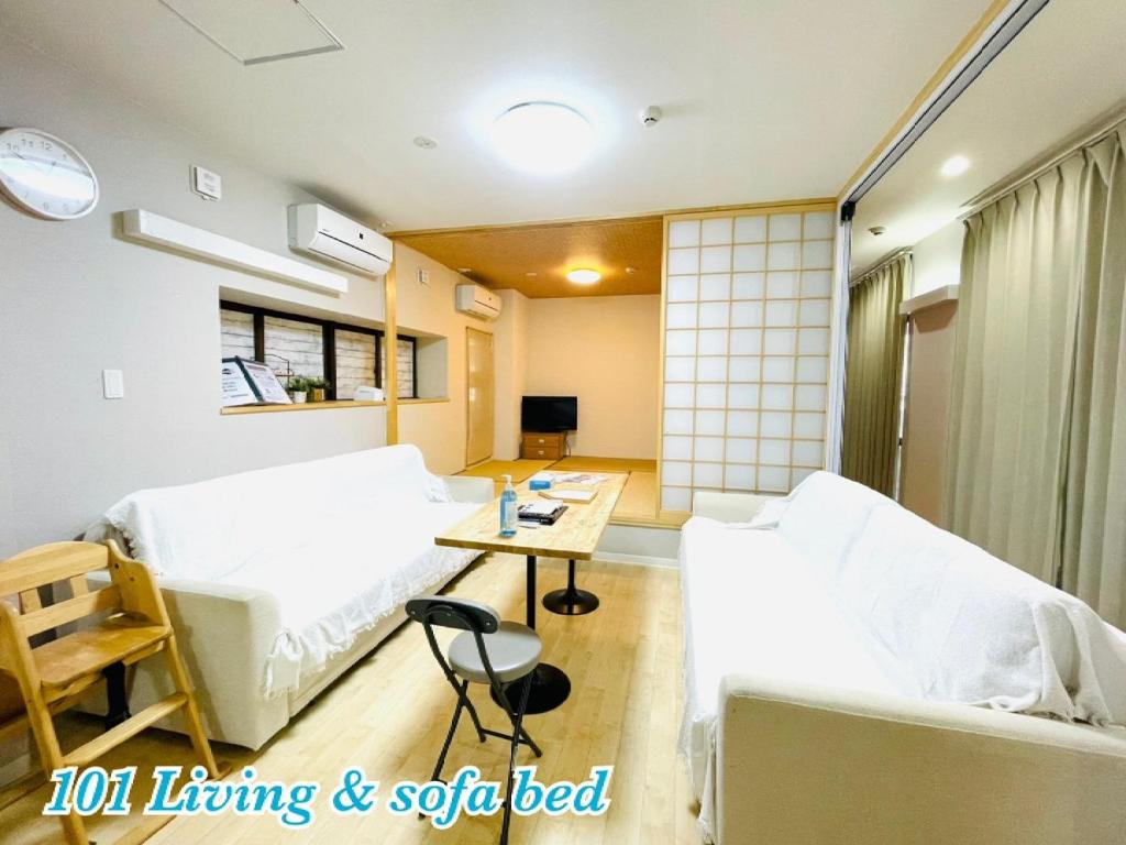 a living room with two beds and a table at Mcity in WAKASA - Vacation STAY 54011v in Naha