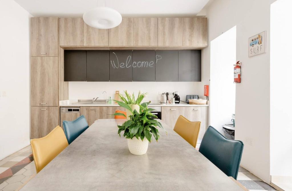 a kitchen with a table with chairs and a plant at Hammock Vibes Town House in Sliema