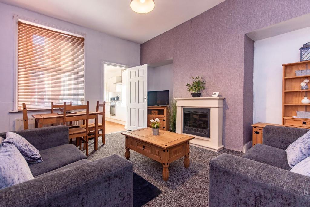 a living room with two couches and a table at Tamworth 99 - 2BR House Near St James Park in Newcastle upon Tyne