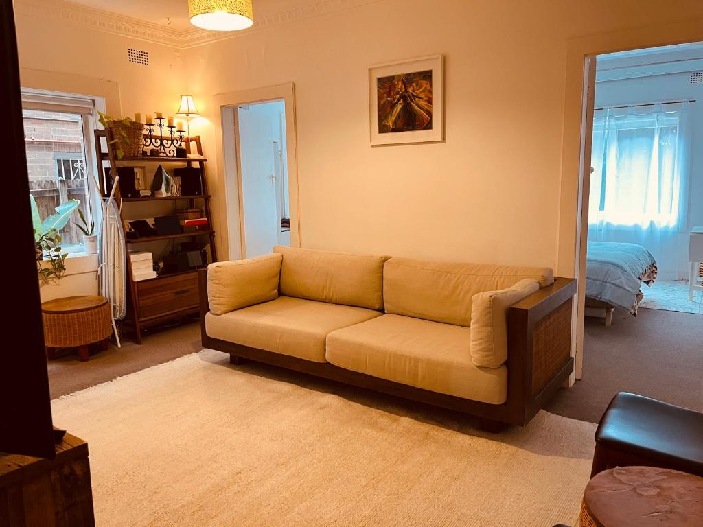 sala de estar con sofá y dormitorio en Little White Heaven - shared apartment, en Sídney