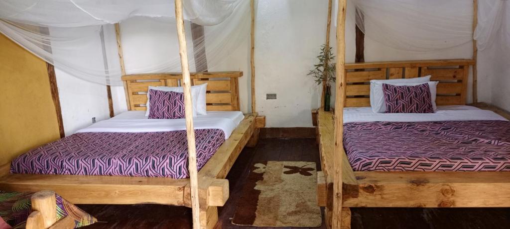Postel nebo postele na pokoji v ubytování Bwindi My Home