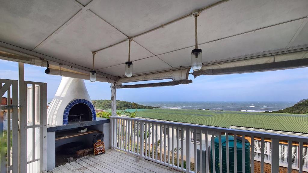 a balcony with a pizza oven and a stove at Ocean Crest Villa in Cintsa Mouth West
