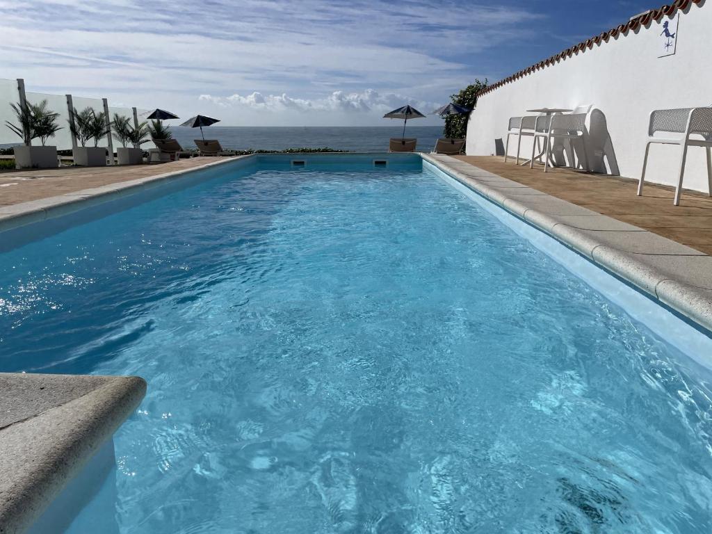 a swimming pool with a view of the ocean at La Sirena del Viento in Los Caños de Meca