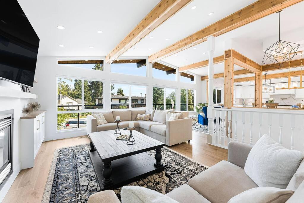 a living room with a couch and a table at A Custom Luxury House Near Metrotown/YVR/SFU in Burnaby