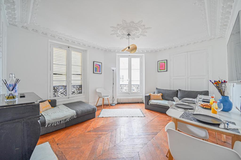 a living room with a couch and a table at Le Ruby D'Hauteville - Coeur de Paris - Unique - Spacieux 6 couchages in Paris