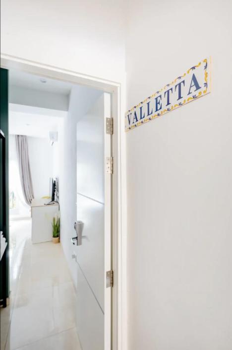 an open door with a sign that reads villa at Hammock Vibes Town House in Sliema