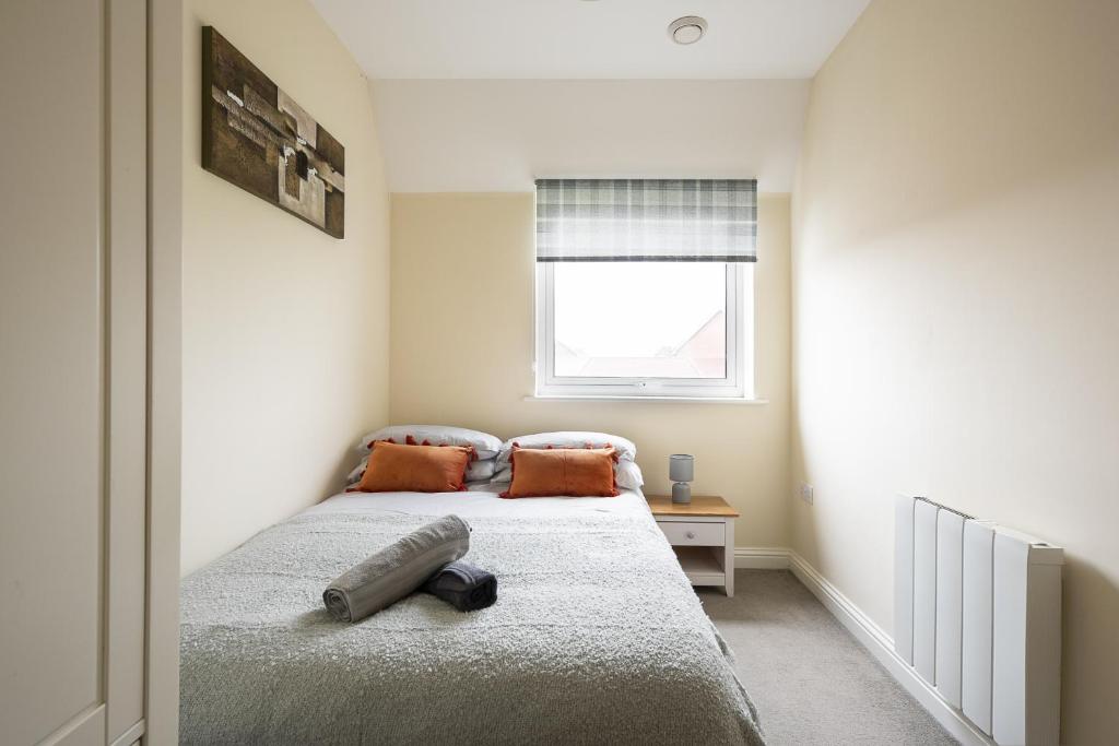 a bedroom with a bed and a window at Inaras place in Aylesbury