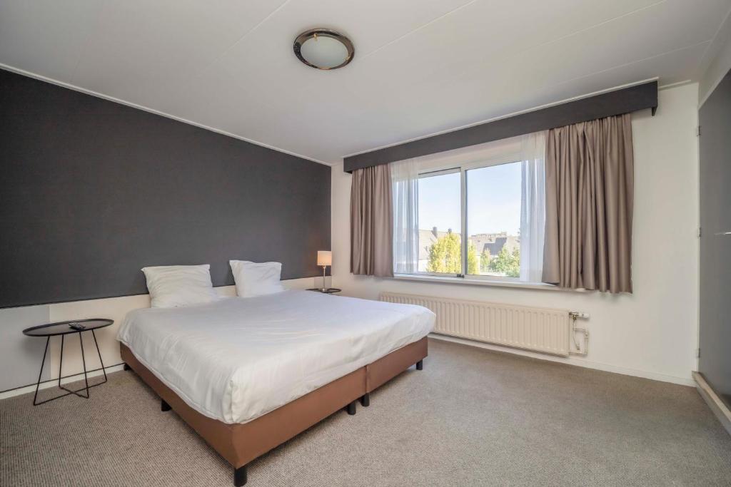 Postel nebo postele na pokoji v ubytování Fletcher Hotel-Restaurant Waalwijk