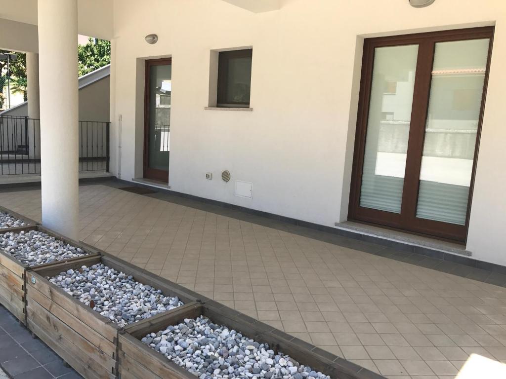 a patio with rocks on the side of a house at RESIDENCE DUINO MARE1 in Duino