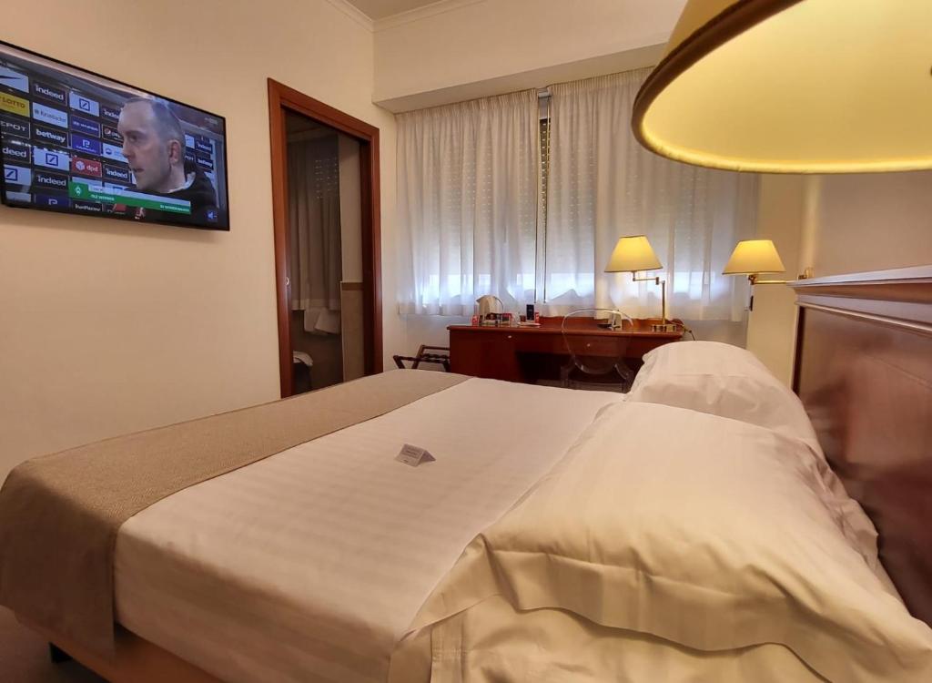 Postel nebo postele na pokoji v ubytování Hotel Plaza