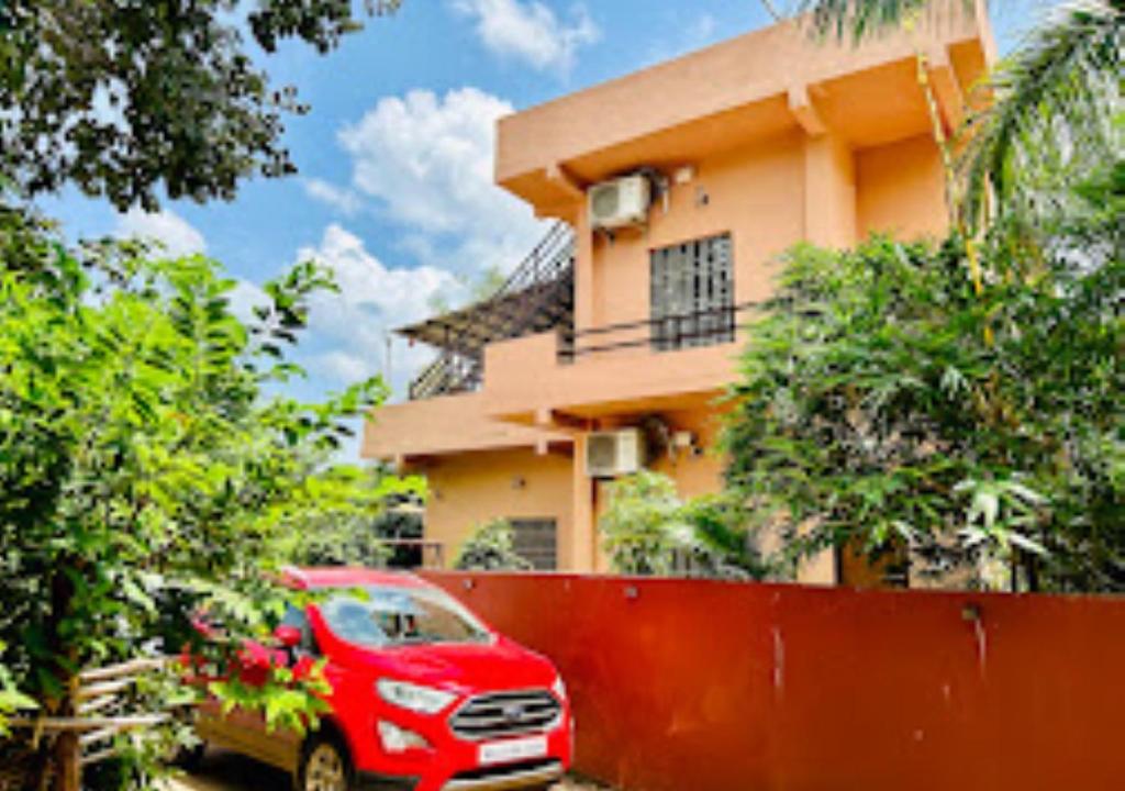 a red truck parked in front of a house at Erisha Tadoba Chandrapur in Mohurli
