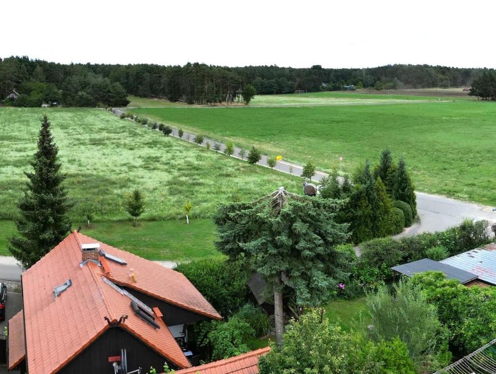 an aerial view of a field and a house at Spreewaldferienwohnungen Stein - Ferienhaus Bela Górka in Byhleguhre-Byhlen