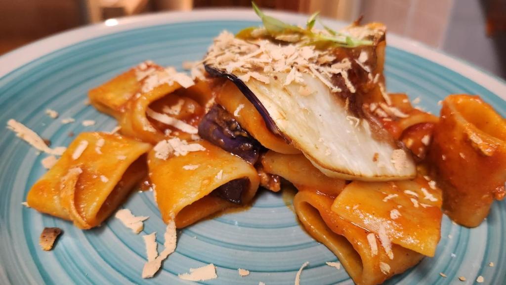a blue plate with some food on it at Taormina Garden Hotel in Taormina