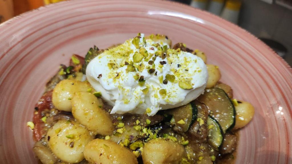 a plate of food with eggs on top of pasta at Taormina Garden Hotel in Taormina