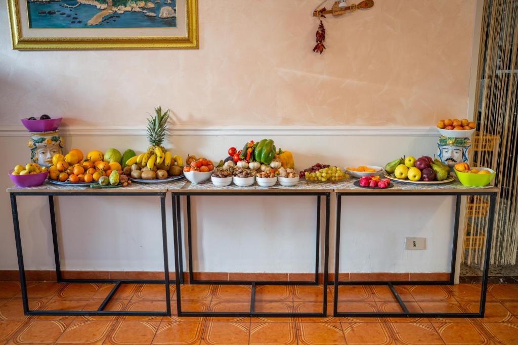 a table filled with lots of fruits and vegetables at Taormina Garden Hotel in Taormina