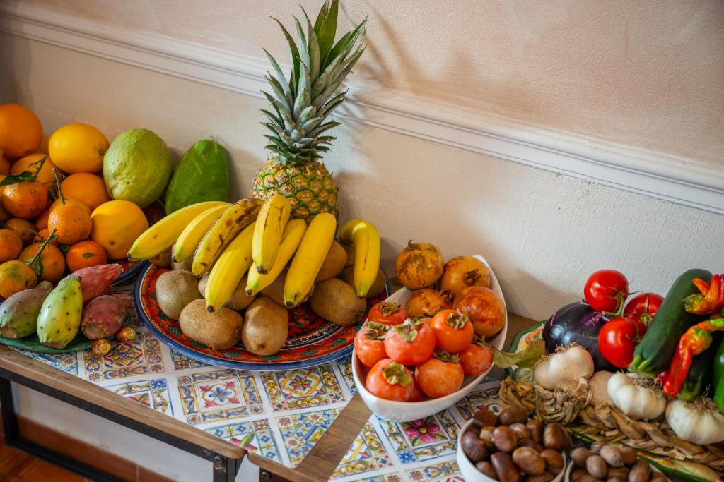 a table topped with lots of fruits and vegetables at Taormina Garden Hotel in Taormina