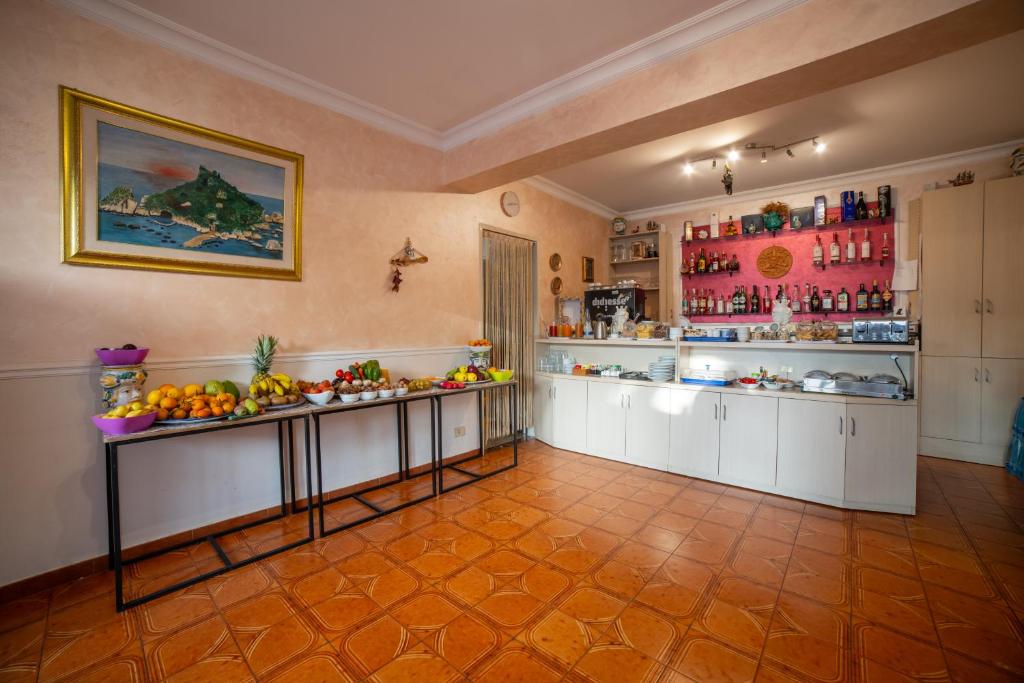 a large kitchen with fruits and vegetables on display at Taormina Garden Hotel in Taormina