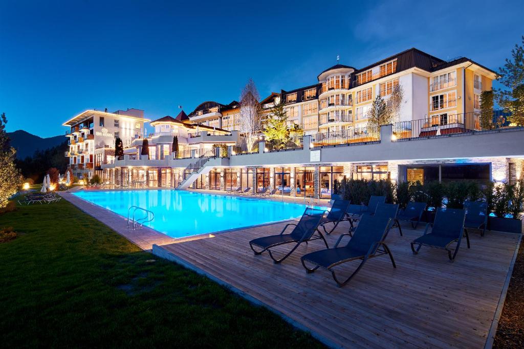 a hotel with a swimming pool at night at Hotel Panorama Royal in Bad Häring
