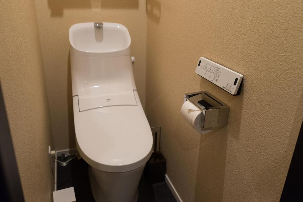 a bathroom with a white toilet in a room at Guesthouse ZenNichi in Kyoto
