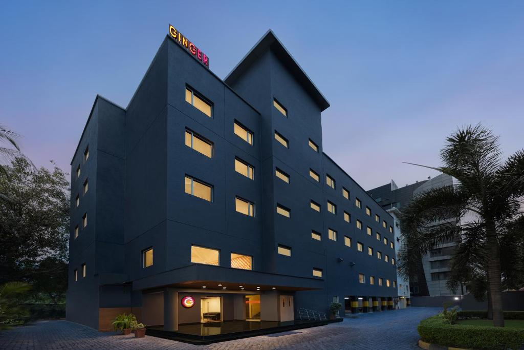 a black building with lights on top of it at Ginger Surat in Surat