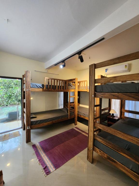 a room with several bunk beds in it at Cliff & Coral in Varkala