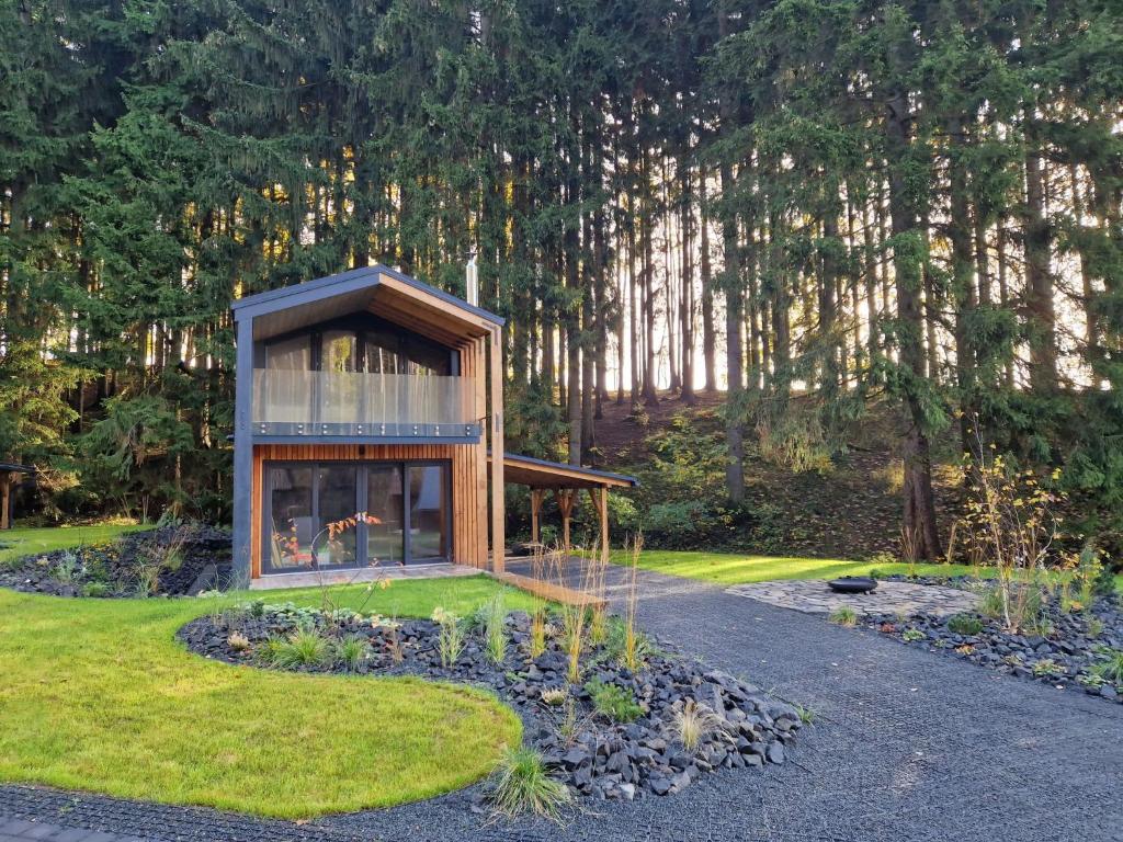 a small house in the middle of a garden at Chalet Luxe Timber Lodge & Pet Retreat by Interhome in Mladé Buky