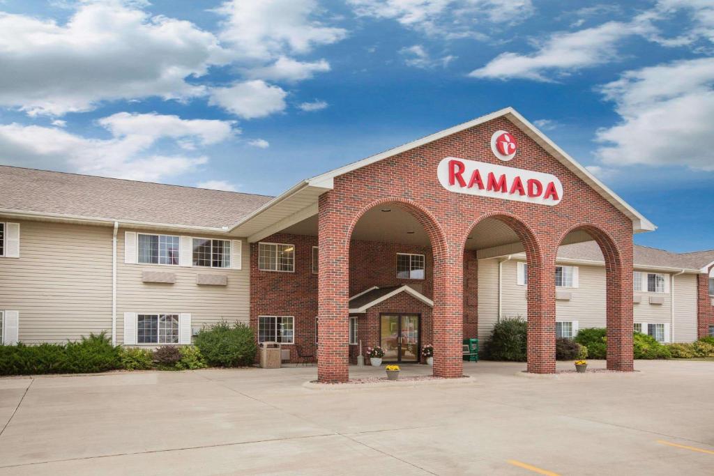 a ramada hotel with a sign on the front of it at Ramada by Wyndham Spirit Lake/Okoboji in Spirit Lake