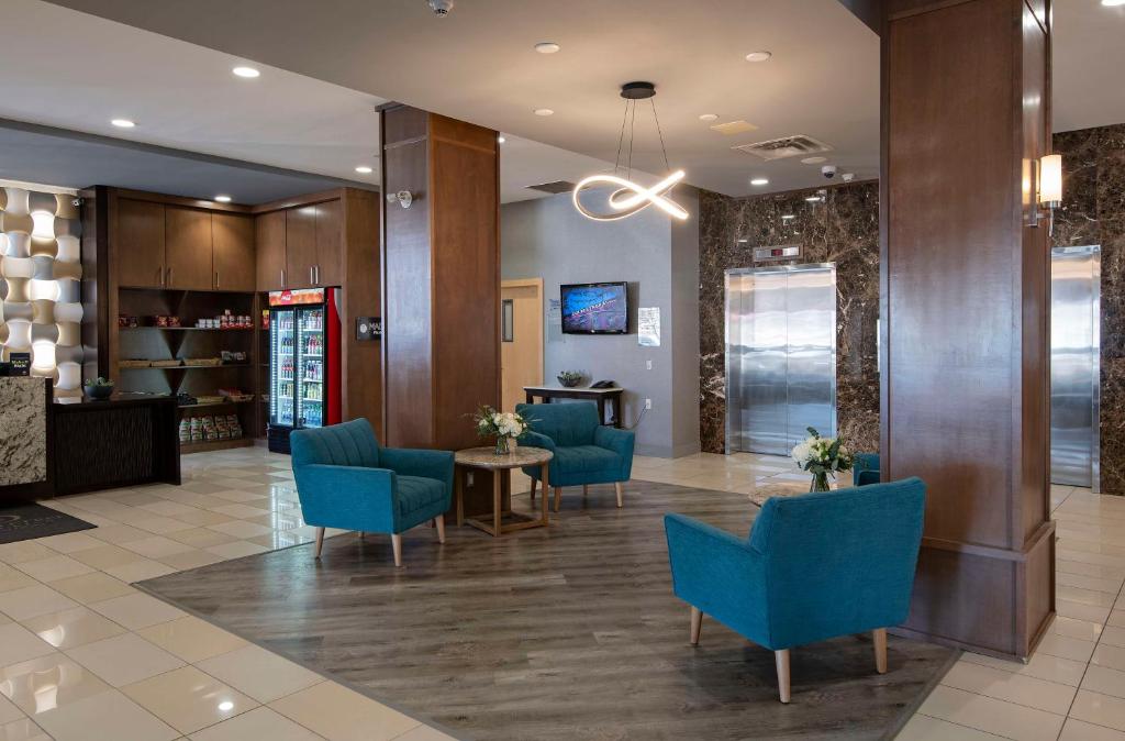 a lobby with blue chairs and a waiting room at DoubleTree by Hilton - Kamloops in Kamloops
