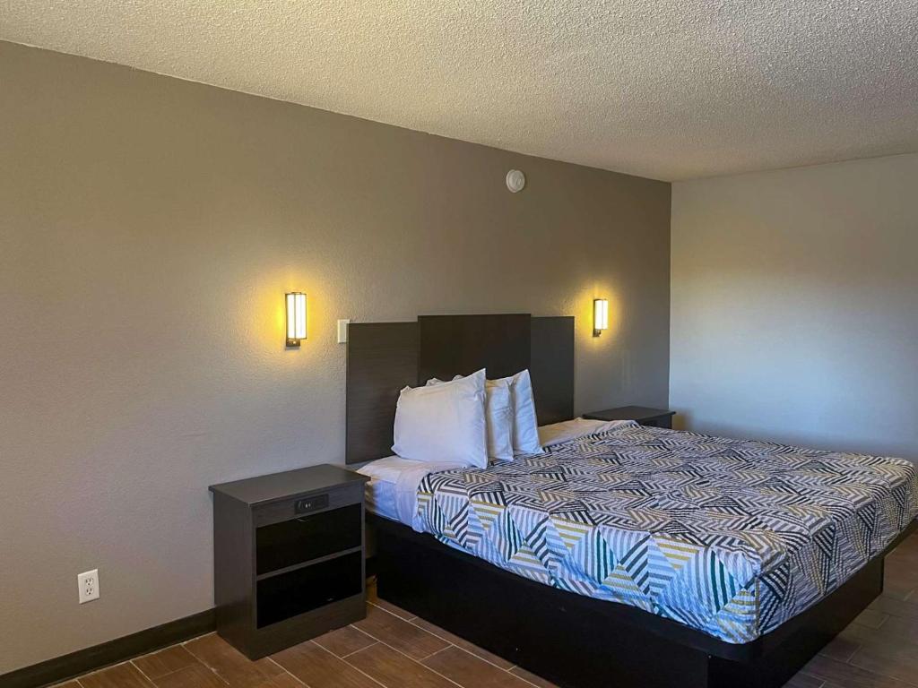una camera d'albergo con letto e cuscini bianchi di Motel 6 Hurricane, WV a Hurricane