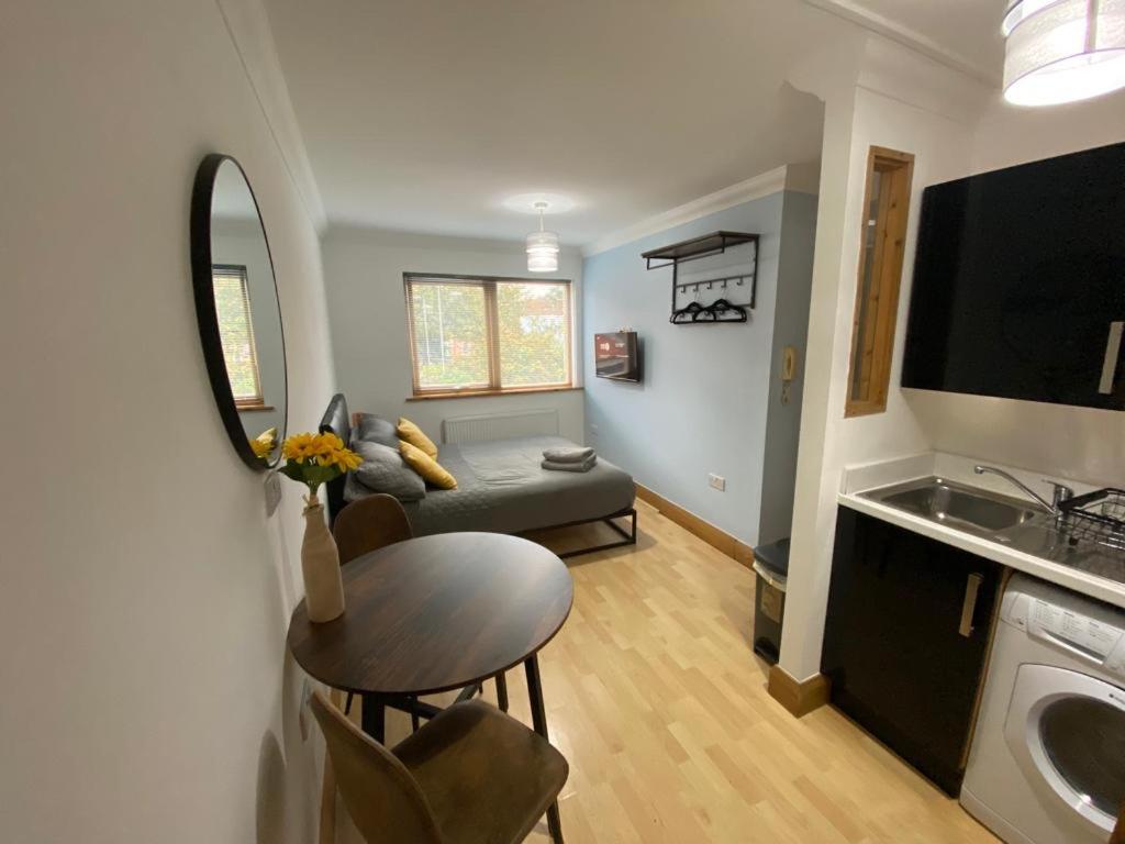 a small living room with a table and a couch at Studio apartment in Norwich City centre in Norwich