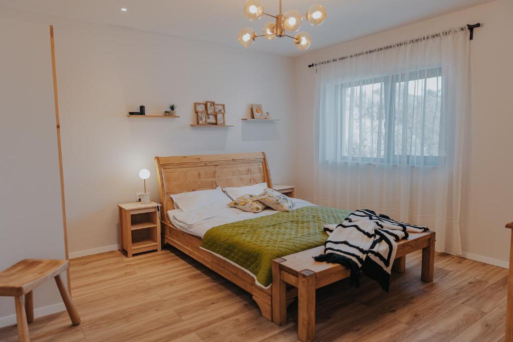 a bedroom with a bed and a chandelier at IoanaGuestHouse in Turda