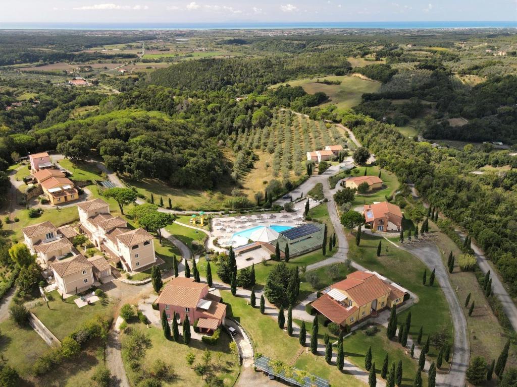 an aerial view of a house with a pool and trees at Apartment Il Felciaione-18 by Interhome in Riparbella