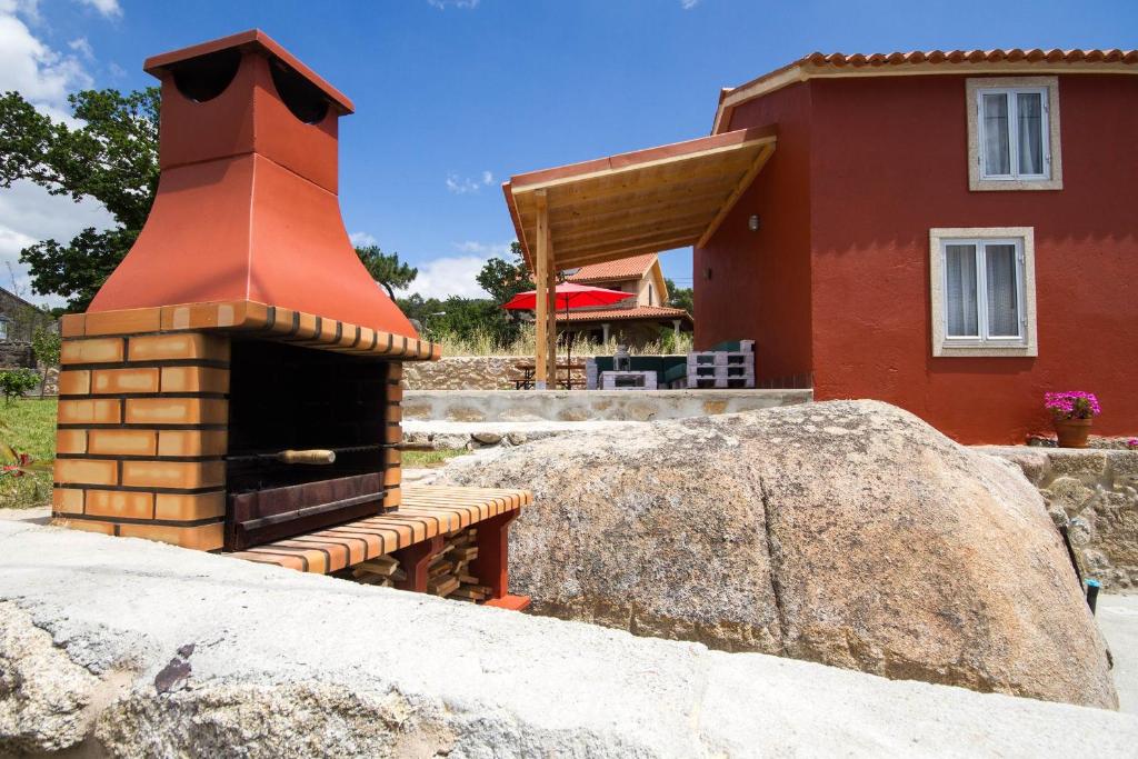 a brick oven in front of a house at Casa Menora Playa de Carnota in Carnota