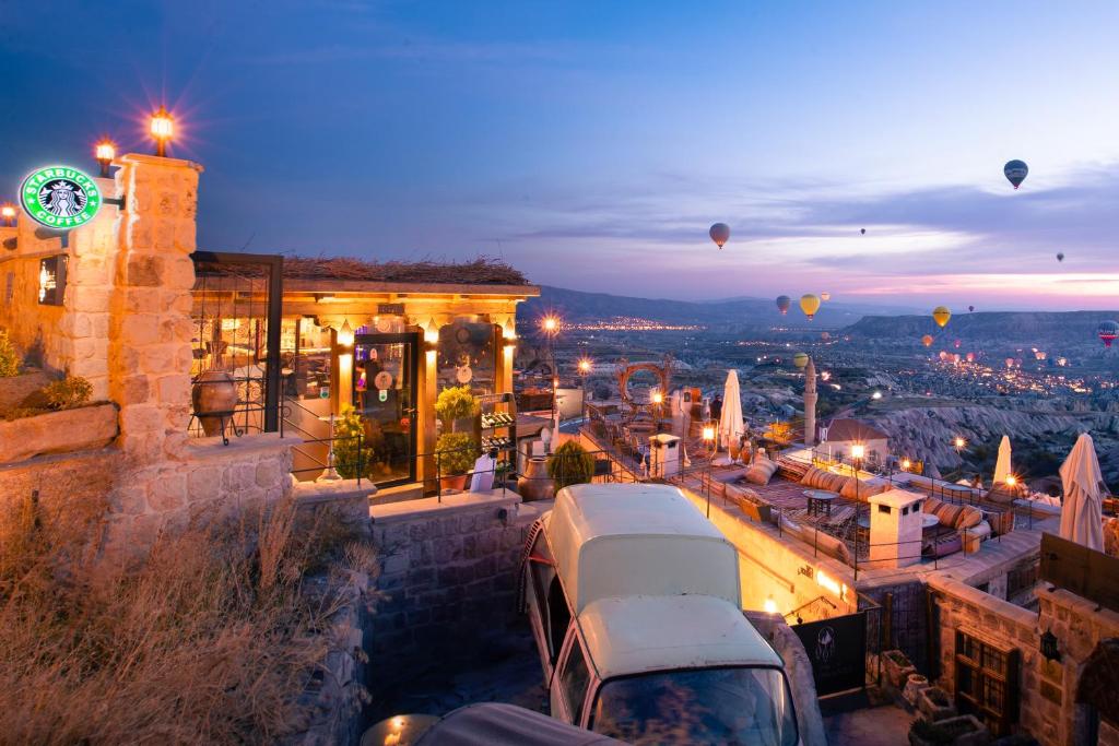 una vista de la ciudad por la noche con globos de aire caliente en Dream of Cappadocia, en Uchisar