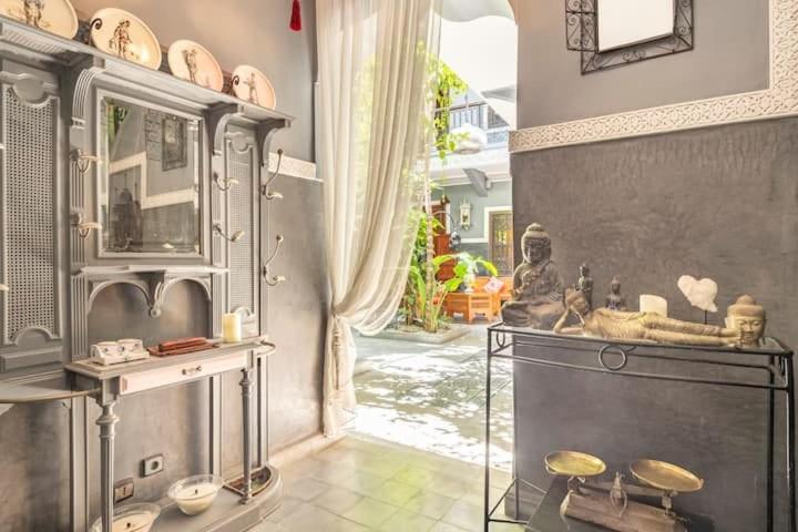 a living room with a table and a window at Riad des Mile Nuits in Marrakesh