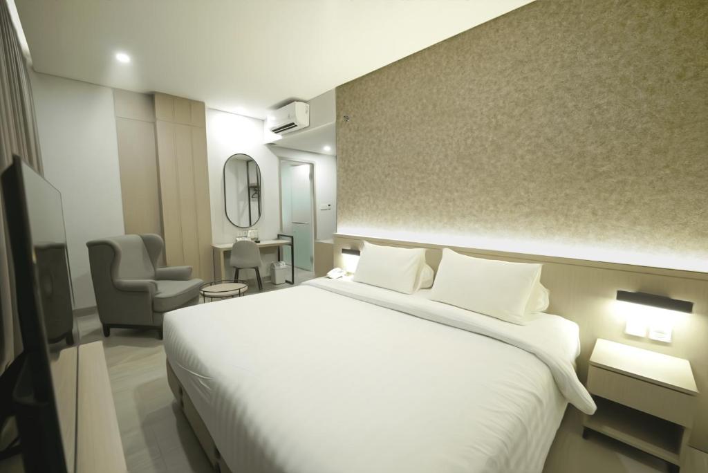 Postel nebo postele na pokoji v ubytování Front One Boutique Hotel Taman Anggrek