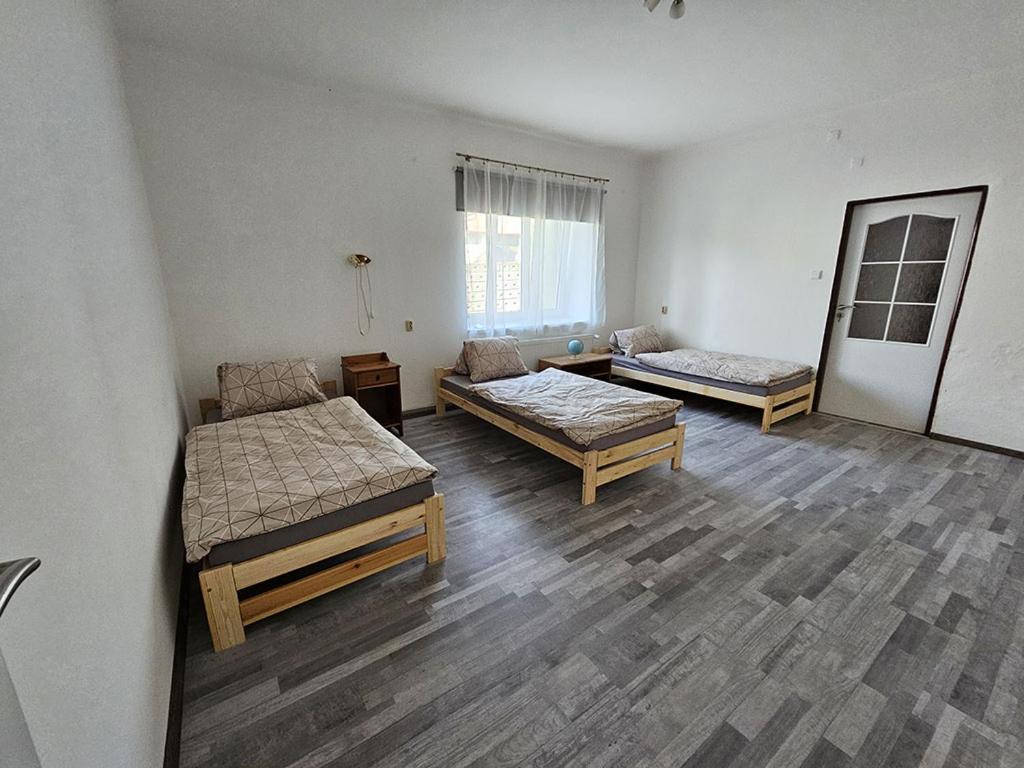 a room with two beds and a couch in it at Dvůr Radouš in Hostomice
