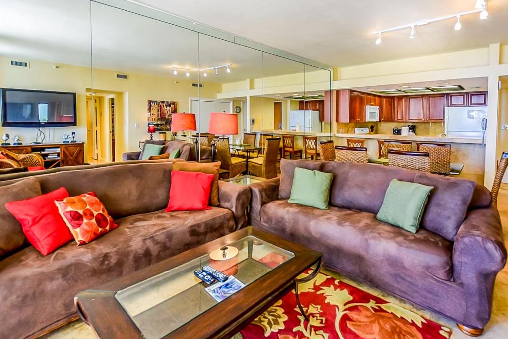 a living room with two couches and a kitchen at East Pass Towers 302 in Destin